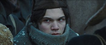 Movie still from “The Way Back” (2010), directed by Peter Weir – A man with a beard and a hat on; Close Up shot, Low angle