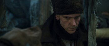 Movie still from “The Way Back” (2010), directed by Peter Weir – A person wearing a hat; Close Up shot, Low angle