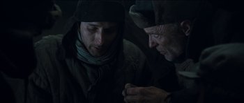 Movie still from “The Way Back” (2010), directed by Peter Weir – A man and an old man looking at each other; Close Up shot, Low angle