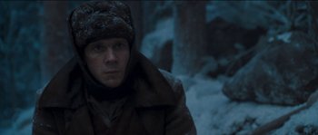 Movie still from “The Way Back” (2010), directed by Peter Weir – A man wearing a coat and hat in the snow; Close Up shot, Low angle