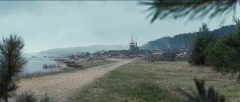 Movie still from “The Way Back” (2010), directed by Peter Weir – An image of an old village with a church in the background; Extreme Wide shot, High angle