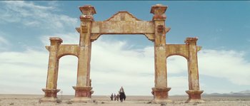 Movie still from “The Way Back” (2010), directed by Peter Weir – An old archway in the middle of a desert; Extreme Wide shot, Low angle