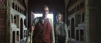 Movie still from “The Way Back” (2010), directed by Peter Weir – A man and a woman standing next to each other; Medium shot, Low angle