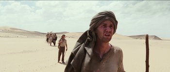 Movie still from “The Way Back” (2010), directed by Peter Weir – A group of people walking in the desert; Medium shot, Low angle