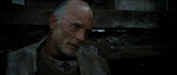 Movie still from “The Way Back” (2010), directed by Peter Weir – An old man with a beard and a white mustache; Close Up shot, Low angle