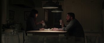 Movie still from “The Way Back” (2020), directed by Gavin O'Connor – A man and a woman sitting at a dinner table; Medium shot, High angle
