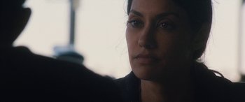 Movie still from “The Way Back” (2020), directed by Gavin O'Connor – A woman's face in a dark room; Close Up shot, Over the shoulder angle