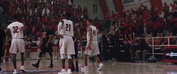 Movie still from “The Way Back” (2020), directed by Gavin O'Connor – A group of men playing a game of basketball in front of an audience; Extreme Wide shot, High angle