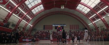 Movie still from “The Way Back” (2020), directed by Gavin O'Connor – A group of people playing basketball in a gym; Extreme Wide shot, High angle