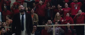 Movie still from “The Way Back” (2020), directed by Gavin O'Connor – A group of people in a gym watching a game; Medium shot, Over the shoulder angle