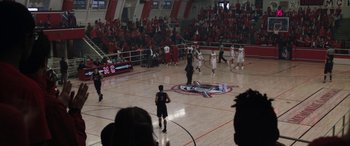Movie still from “The Way Back” (2020), directed by Gavin O'Connor – A group of men playing a game of basketball in an arena; Extreme Wide shot, High angle