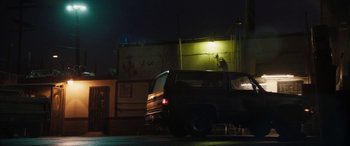 Movie still from “The Way Back” (2020), directed by Gavin O'Connor – A car parked on the side of the road at night; Wide shot, Low angle
