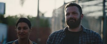 Movie still from “The Way Back” (2020), directed by Gavin O'Connor – A man with a beard standing next to another man; Close Up shot, Over the shoulder angle