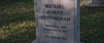 Movie still from “The Way Back” (2020), directed by Gavin O'Connor – A grave marker with the name of michael joseph cunningham; Extreme Close Up shot, High angle