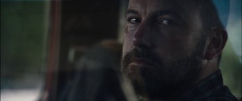 Movie still from “The Way Back” (2020), directed by Gavin O'Connor – A person with a beard; Close Up shot, Over the shoulder angle