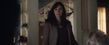 Movie still from “The Way Back” (2020), directed by Gavin O'Connor – A woman standing in front of a doorway; Close Up shot, Over the shoulder angle