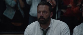Movie still from “The Way Back” (2020), directed by Gavin O'Connor – A person wearing a shirt and a tie; Close Up shot, Over the shoulder angle
