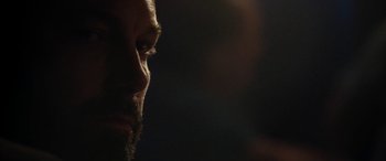Movie still from “The Way Back” (2020), directed by Gavin O'Connor – A man's face in the dark; Extreme Close Up shot, Over the shoulder angle