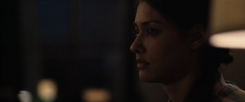 Movie still from “The Way Back” (2020), directed by Gavin O'Connor – A woman's face in the dark; Close Up shot, Over the shoulder angle