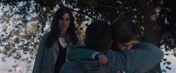 Movie still from “The Way Back” (2020), directed by Gavin O'Connor – A woman standing next to a man and a child; Close Up shot, Over the shoulder angle
