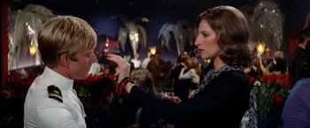 Movie still from “The Way We Were” (1973), directed by Sydney Pollack – Two women are talking to each other at a party; Close Up shot, Over the shoulder angle