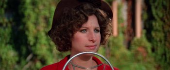 Movie still from “The Way We Were” (1973), directed by Sydney Pollack – A person wearing a hat and holding an object; Close Up shot, High angle