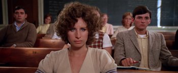 Movie still from “The Way We Were” (1973), directed by Sydney Pollack – A person sitting in front of a group of people; Close Up shot, High angle