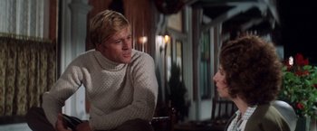 Movie still from “The Way We Were” (1973), directed by Sydney Pollack – A man and a woman are talking in a room; Medium shot, Over the shoulder angle