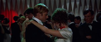 Movie still from “The Way We Were” (1973), directed by Sydney Pollack – A man and a woman in formal wear dancing together; Medium shot, Low angle