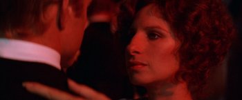 Movie still from “The Way We Were” (1973), directed by Sydney Pollack – A woman's face in a dark room; Close Up shot, Over the shoulder angle