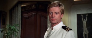 Movie still from “The Way We Were” (1973), directed by Sydney Pollack – A person wearing a suit and tie; Close Up shot, Low angle