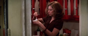 Movie still from “The Way We Were” (1973), directed by Sydney Pollack – A woman is putting something in a bowl; Medium shot, High angle