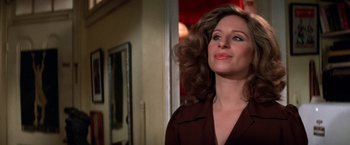 Movie still from “The Way We Were” (1973), directed by Sydney Pollack – A woman in a brown shirt looking up at the ceiling; Close Up shot, Over the shoulder angle