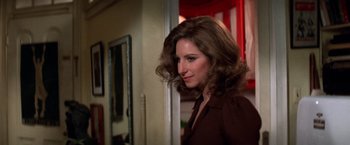 Movie still from “The Way We Were” (1973), directed by Sydney Pollack – A woman standing next to a red door; Close Up shot, Over the shoulder angle