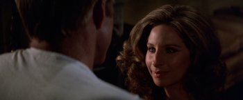 Movie still from “The Way We Were” (1973), directed by Sydney Pollack – A man and a woman looking at one another; Close Up shot, Over the shoulder angle
