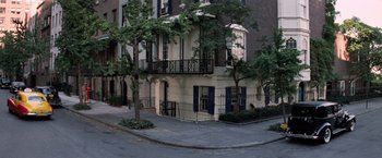 Movie still from “The Way We Were” (1973), directed by Sydney Pollack – A building on a street corner near a tree; Extreme Wide shot, High angle