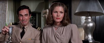 Movie still from “The Way We Were” (1973), directed by Sydney Pollack – A person wearing a suit and a pearl necklace; Close Up shot, Low angle