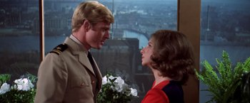 Movie still from “The Way We Were” (1973), directed by Sydney Pollack – A man and a woman standing next to each other holding flowers; Close Up shot, Over the shoulder angle