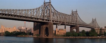 Movie still from “The Way We Were” (1973), directed by Sydney Pollack – A large bridge over a body of water; Extreme Wide shot, Low angle