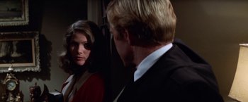 Movie still from “The Way We Were” (1973), directed by Sydney Pollack – A man and a woman standing next to each other in a room; Close Up shot, Over the shoulder angle
