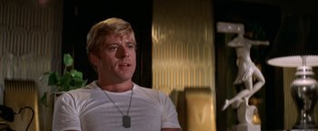 Movie still from “The Way We Were” (1973), directed by Sydney Pollack – A person wearing a white t - shirt; Close Up shot, Low angle