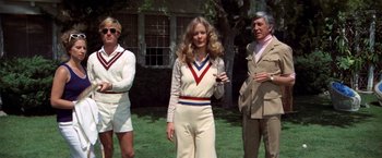 Movie still from “The Way We Were” (1973), directed by Sydney Pollack – A woman standing next to two men on a lawn; Wide shot, High angle