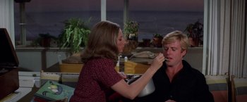 Movie still from “The Way We Were” (1973), directed by Sydney Pollack – A woman putting makeup on another woman's face; Medium shot, Over the shoulder angle