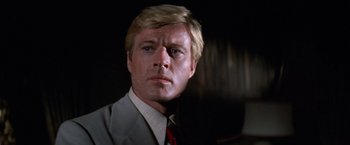 Movie still from “The Way We Were” (1973), directed by Sydney Pollack – A person wearing a suit and tie; Close Up shot, Low angle