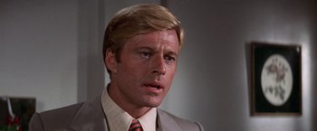 Movie still from “The Way We Were” (1973), directed by Sydney Pollack – A person wearing a suit and tie; Close Up shot, Low angle
