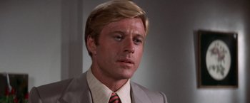 Movie still from “The Way We Were” (1973), directed by Sydney Pollack – A person wearing a suit and tie; Close Up shot, Over the shoulder angle