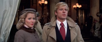 Movie still from “The Way We Were” (1973), directed by Sydney Pollack – A man and a woman standing next to each other; Close Up shot, Low angle