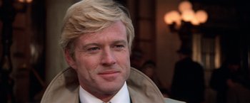 Movie still from “The Way We Were” (1973), directed by Sydney Pollack – A person wearing a suit and tie; Close Up shot, Over the shoulder angle