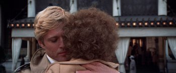 Movie still from “The Way We Were” (1973), directed by Sydney Pollack – A man and a woman embracing each other; Close Up shot, Over the shoulder angle