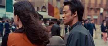 Movie still from “The Way of the Dragon” (1972), directed by Bruce Lee – A person in a crowd of onlookers; Close Up shot, Low angle